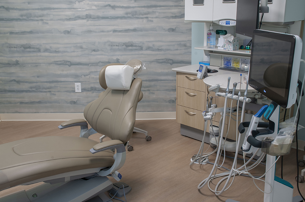 Treatment chair with calming watercolor wall at Waterstone Family Dentistry