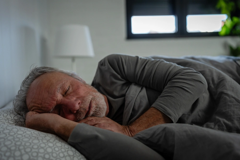Patient resting in bed for sleep apnea care